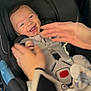 Theodore is registered to the contest to win money with this photo: baby, infant, smiling, car_seat, seatbelt, harness, hands, adult_hands, buckle, stuffed_animal, toy, dimples, closeup, portrait, happy, cozy, parent_interaction, travel, black_upholstery, safety
