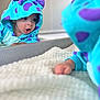 Alan joined the competition — help win amazing prizes! baby, blanket, blue, child, costume, curious, cute, expression, face, headwear, indoor, infant, lying, mirror, onesie, playful, purple, reflection, soft, tongue