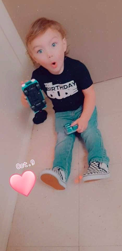 Carsyn is registered to the contest to win money with this photo: arm, baby, baby_toddler_clothing, electric_blue, finger, flooring, human_leg, joint, knee, leg, organ, person, pink, product, sleeve, sock, sportswear, surprise, t_shirt, thigh