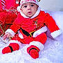baby, child, christmas, holiday, festive, red_clothing, santa_hat, cute, indoors, decorations, lights, white_rug, portrait, smiling, holiday_season, winter_wear, infant, cozy, celebration, festivity