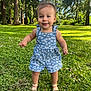 toddler, child, outdoor, grass, flowers, trees, sunlight, blue_sky, romper, footwear, nature, greenery, happy, smiling, portrait, person, summer, cute, daylight, playful
