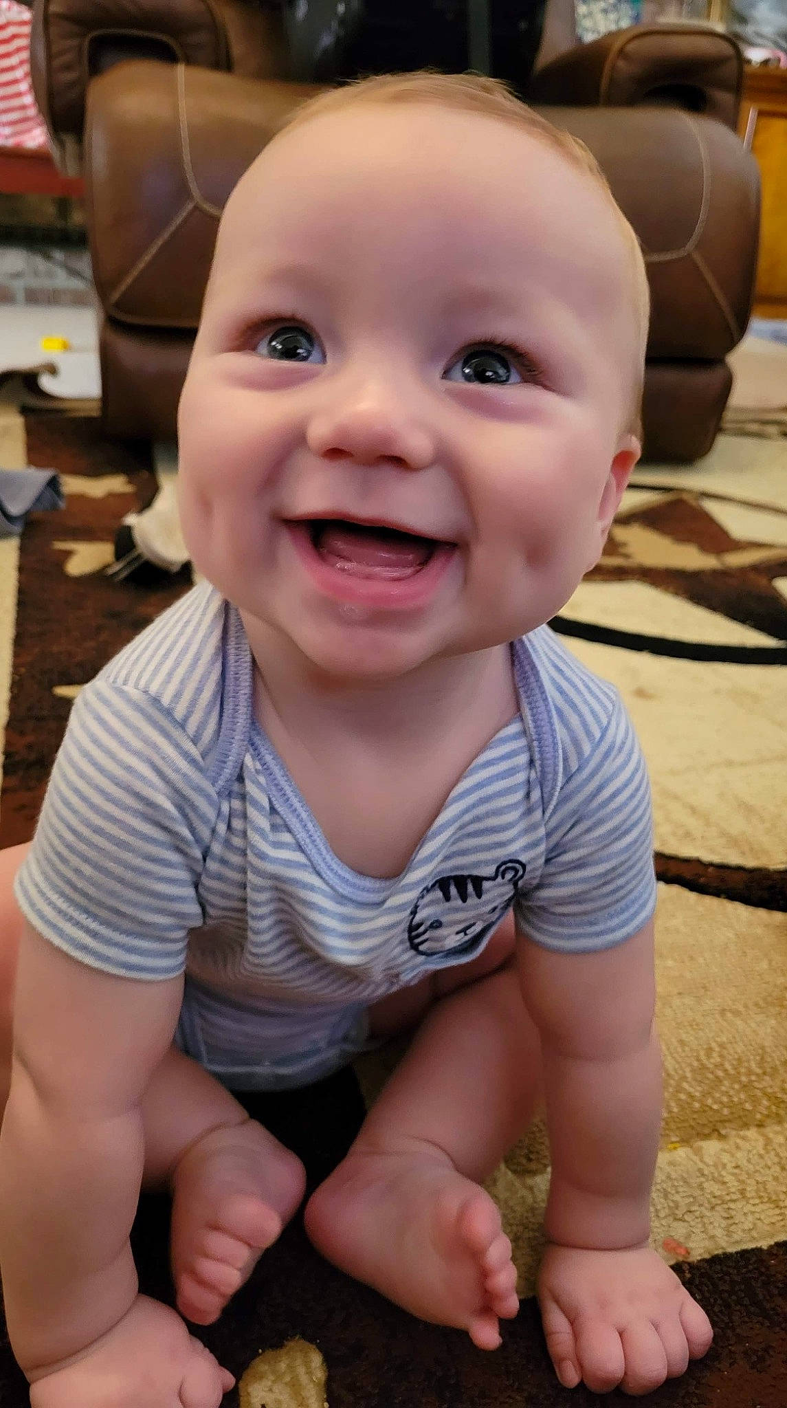 Hunter is registered to the contest to win money with this photo: baby, baby_toddler_clothing, cheek, child, eye, finger, floor, flooring, happy, head, human_body, iris, joy, lip, mouth, nose, person, skin, sleeve, smile