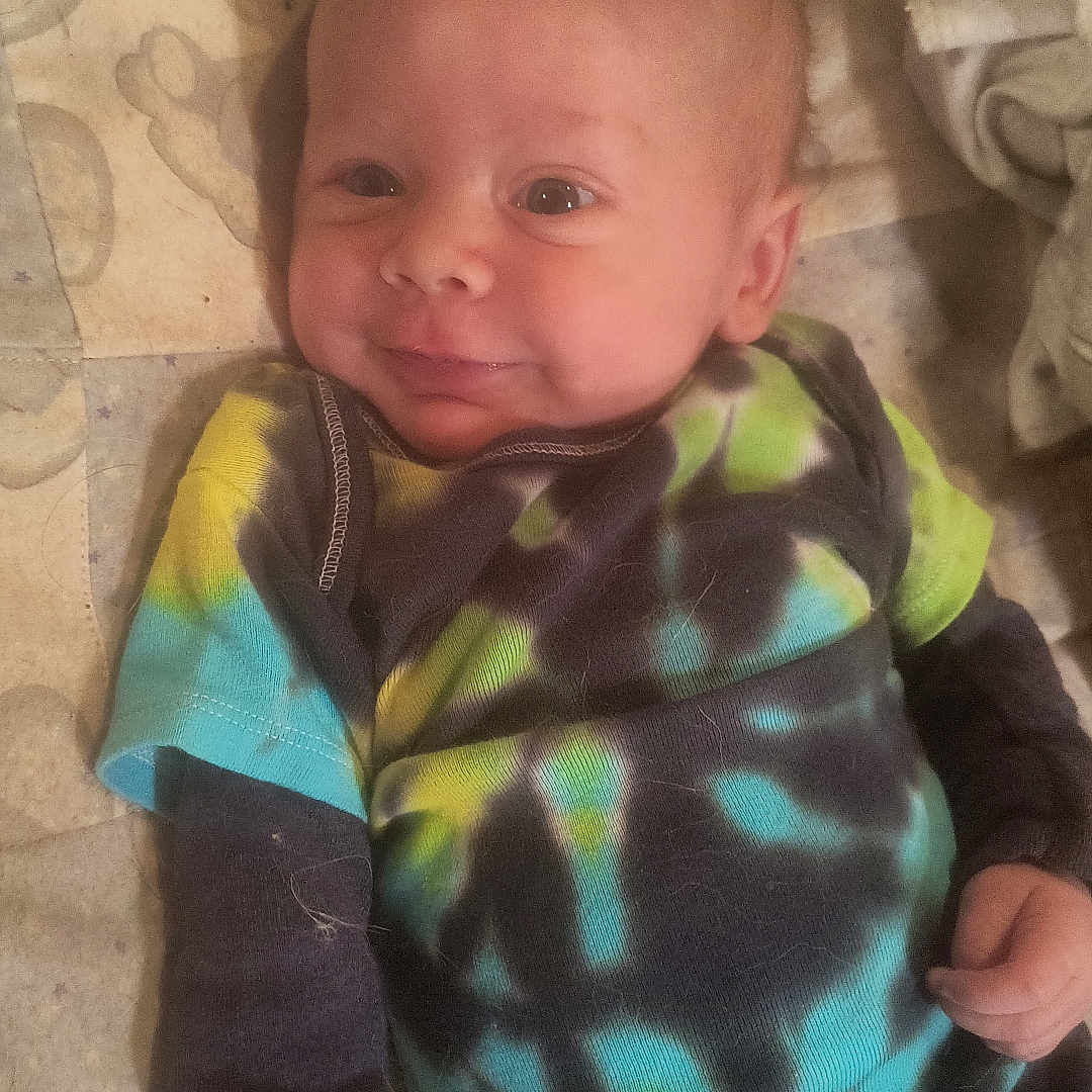 Skylur is registered to the contest to win money with this photo: baby, bodypart, clothing, cushion, face, finger, hand, happy, head, homedecor, hosiery, knitwear, newborn, pants, person, photography, portrait, smile, sock, sweater