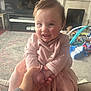 Isabella joined the competition — help win amazing prizes! baby, child, smiling, pink_dress, hand_holding, living_room, toys, carpet, fireplace, couch, person, cute, happy, indoor, portrait, infant, face, clothing, home, play