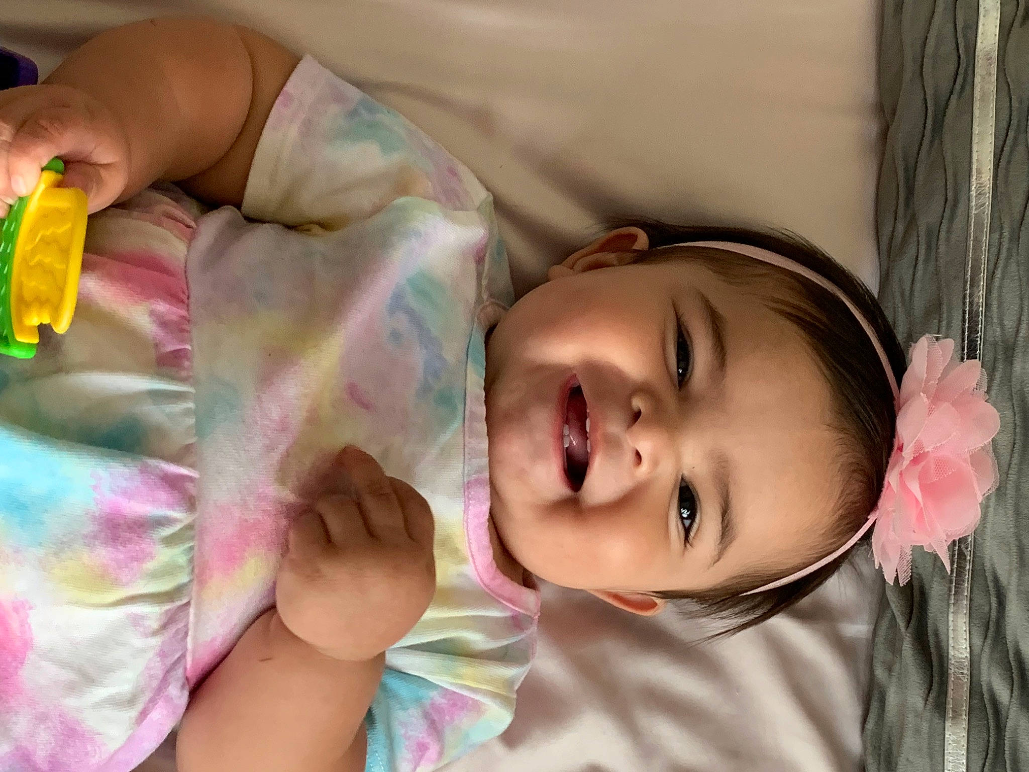 Alyssa is registered to the contest to win money with this photo: arm, baby, baby_toddler_clothing, cheek, eyelash, finger, fun, hand, happy, iris, joy, lip, mouth, nose, person, pink, room, skin, smile, textile