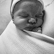Lou participe au concours pour gagner de l'argent avec cette photo : newborn, baby, sleeping, wrapped, blanket, hat, closeup, face, soft, cozy, black_and_white, infant, peaceful, cute, portrait, indoors, skin_texture, swaddled, resting, child