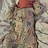 newborn, baby, sleeping, infant, portrait, onesie, hat, bow_pattern, blanket, bed, bedding, cozy, indoors, lying_down, peaceful, closed_eyes, face, clothing, textile, photography