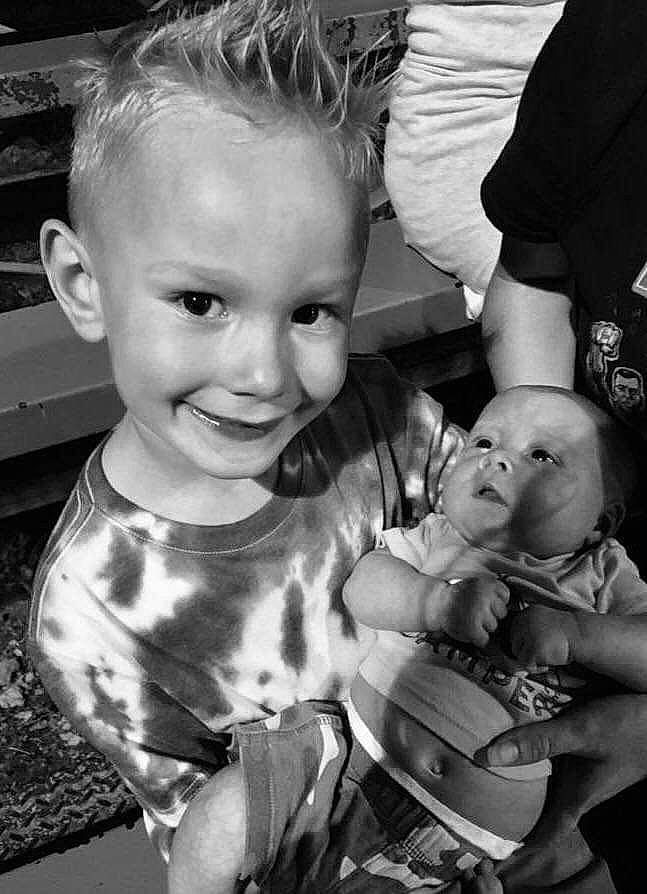 Conner is registered to the contest to win money with this photo: baby, black_and_white, child, family, happy, joy, monochrome, monochrome_photography, people, person, photograph, photography, sibling, sitting, smile, snapshot, style, toddler