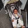 baby, child, stroller, smiling, happy, infant, portrait, seated, outdoor, indoor, travel, carpet, canopy, harness, jumpsuit, pink_clothing, bare_feet, family, photography, chicco