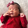 baby, newborn, sleeping, red_clothing, headband, pink_bow, infant, soft_blanket, peaceful, portrait, cute, child, indoors, closeup, tiny_hands, cozy, warm, resting, adorable, person