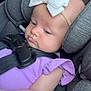 Maycie is registered to the contest to win money with this photo: baby, child, car_seat, headband, bow, purple_clothing, drool, blanket, seatbelt, infant, cute, soft_toys, indoor, car_interior, resting, toddler, closeup, person, young_child, comfort