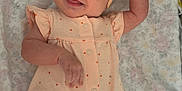 Maycie is registered to the contest to win money with this photo: baby, infant, smiling, headband, bow, romper, polka_dot, lying_down, blanket, floral_pattern, cute, tongue_out, cheerful, child, skin, arm, leg, indoors, happy, portrait
