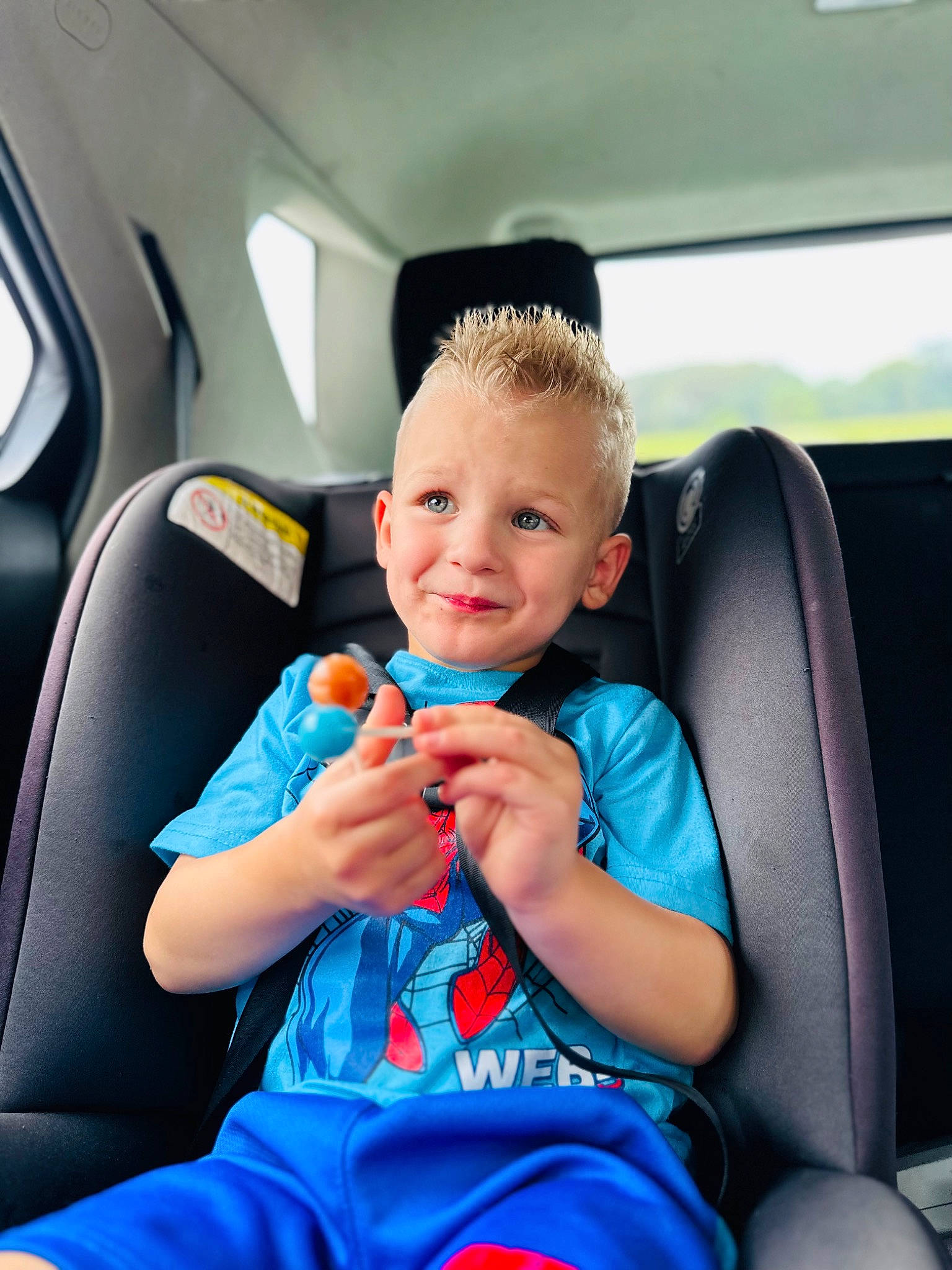 Kaiden is registered to the contest to win money with this photo: air_travel, airline, auto_part, automotive_design, car, car_seat, car_seat_cover, child, comfort, electric_blue, family_car, fun, head_restraint, joy, luxury_vehicle, motor_vehicle, person, seat_belt, smile, toddler