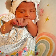 Kaylani joined the competition — help win amazing prizes! baby, sleeping, headband, bow, dress, floral, infant, cushion, rainbow, stars, cute, peaceful, newborn, child, soft, colorful, pattern, resting, indoors, adorable