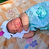 Kaylani is registered to the contest to win money with this photo: newborn, baby, sleeping, blanket, flower_pattern, teddy_bear, soft_fabric, outdoor, sunlight, peaceful, infant, headwear, cute, portrait, resting, child, closeup, skin, small, cozy