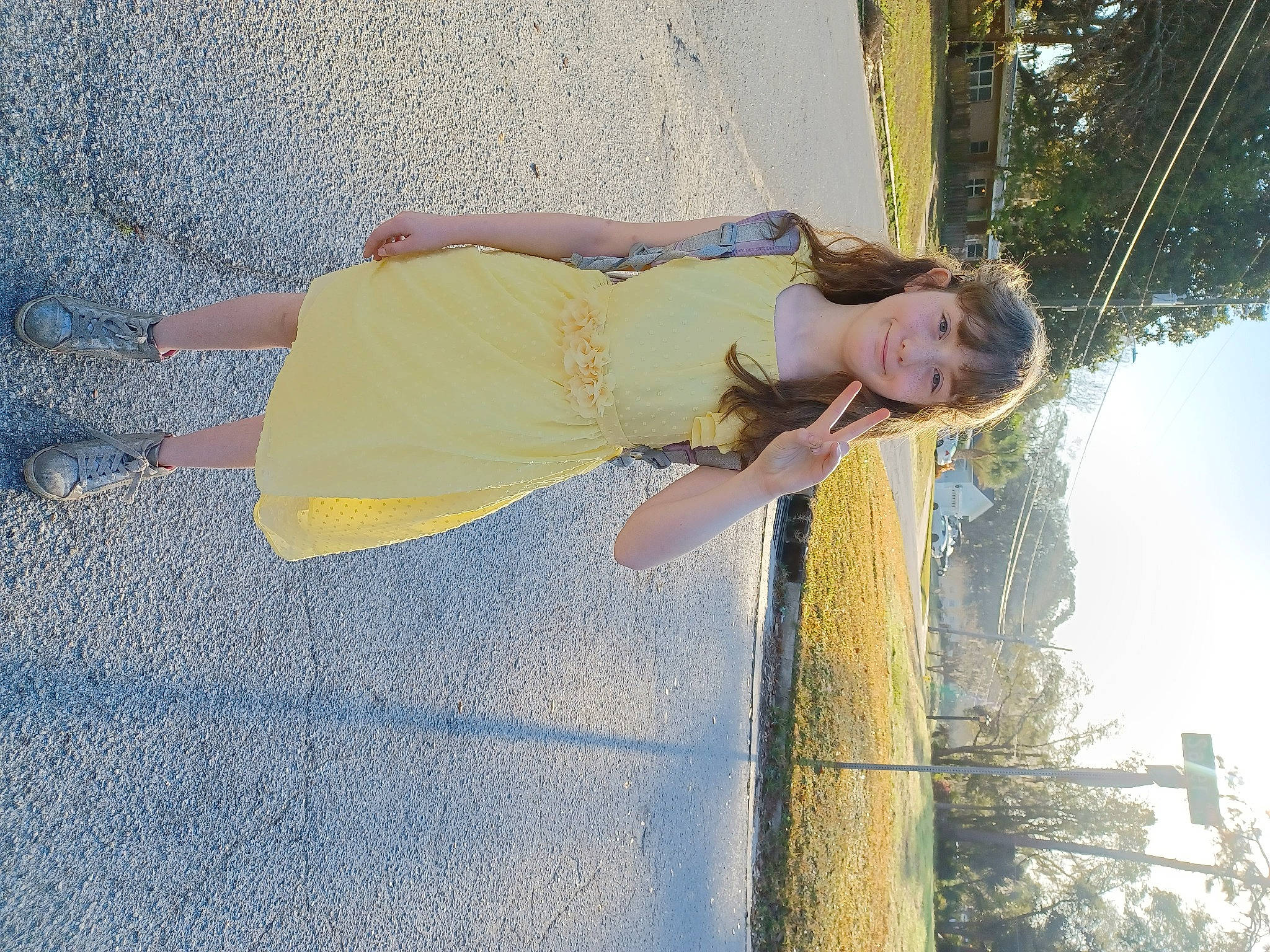 Lillie is registered to the contest to win money with this photo: asphalt, daytime, elbow, flash_photography, fun, gesture, happy, human_leg, joy, leisure, people_in_nature, person, plant, recreation, road_surface, shadow, sky, sunlight, thigh, tints_and_shades