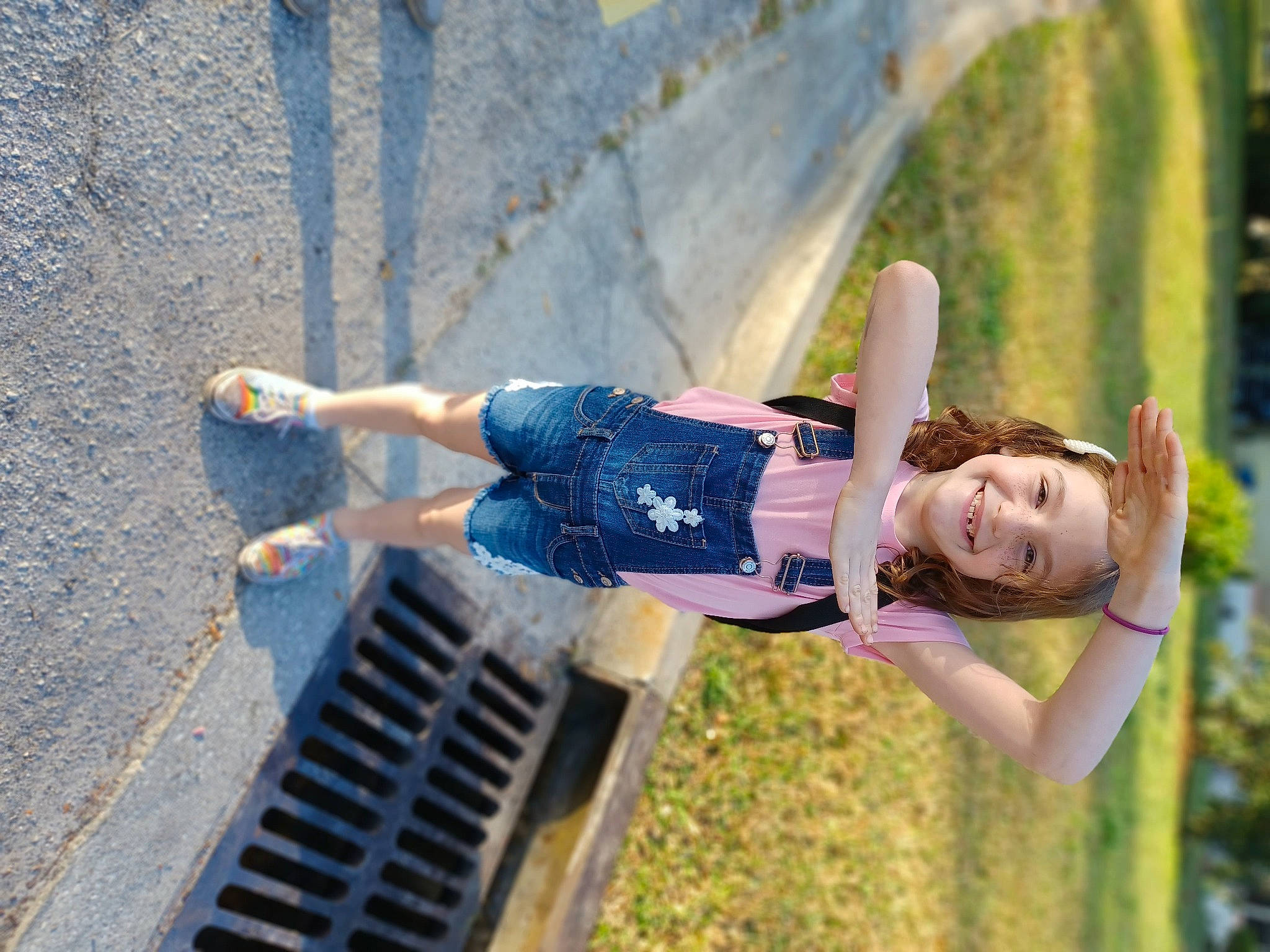 Delilah is registered to the contest to win money with this photo: brown_hair, denim, electric_blue, flash_photography, fun, grass, happy, human_leg, joy, knee, leg, leisure, people_in_nature, person, plant, recreation, sitting, smile, street_fashion, thigh