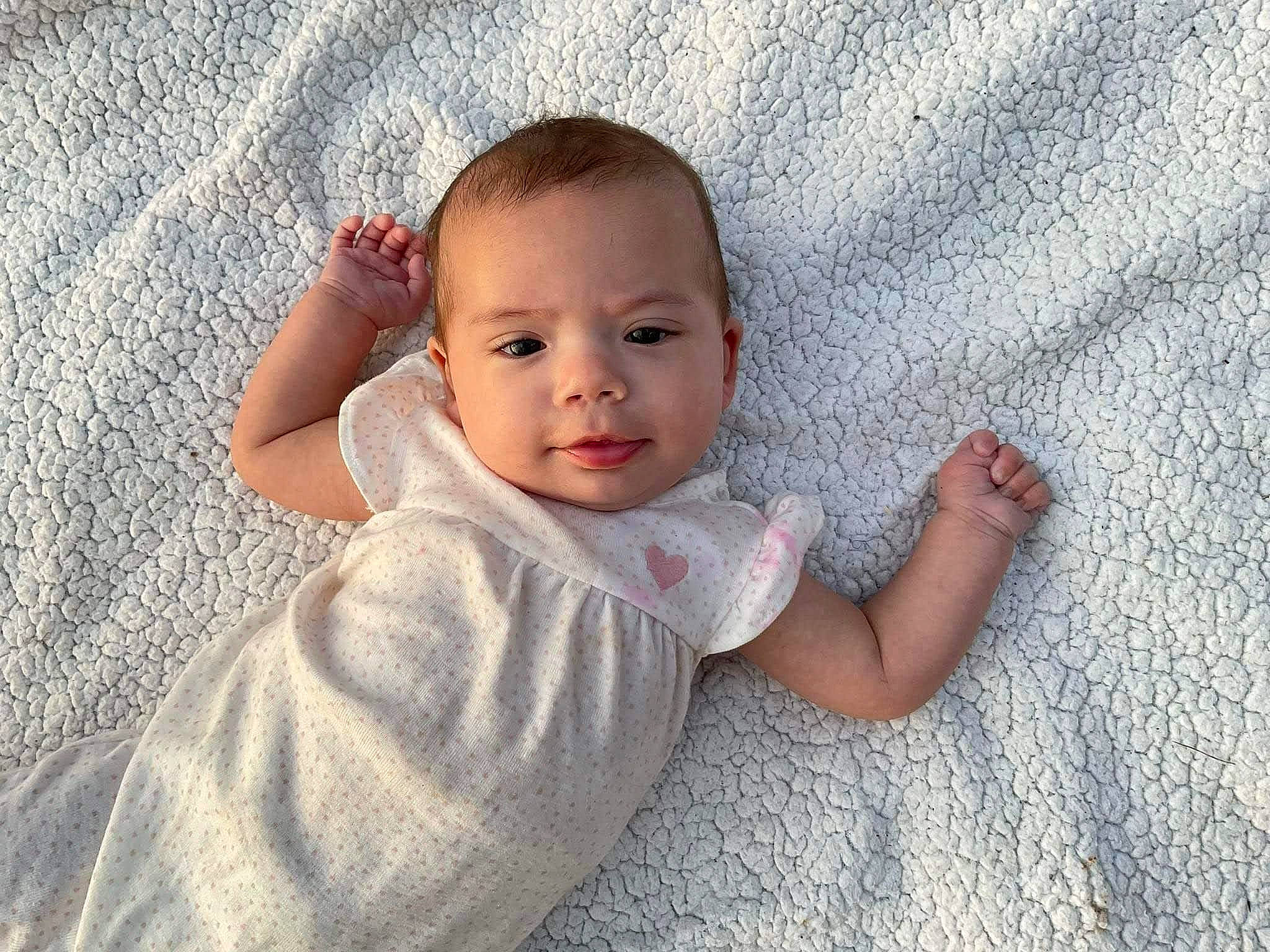 Neveah is registered to the contest to win money with this photo: baby, baby_toddler_clothing, cheek, child, comfort, eye, face, finger, flooring, gesture, hand, happy, head, nose, person, skin, sleeve, textile, thumb, toddler