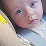 baby, infant, face, car_seat, seatbelt, child, portrait, skin, eyes, clothing, seat, closeup, head, young_child, expression, indoors, cute, person, baby_girl, baby_boy
