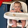 baby, high_chair, biscuit, kitchen, blue_cabinet, granite_countertop, red_cloth, infant, eating, food, child, furniture, flooring, person, indoor, cute, young_child, mealtime, toddlers, foot