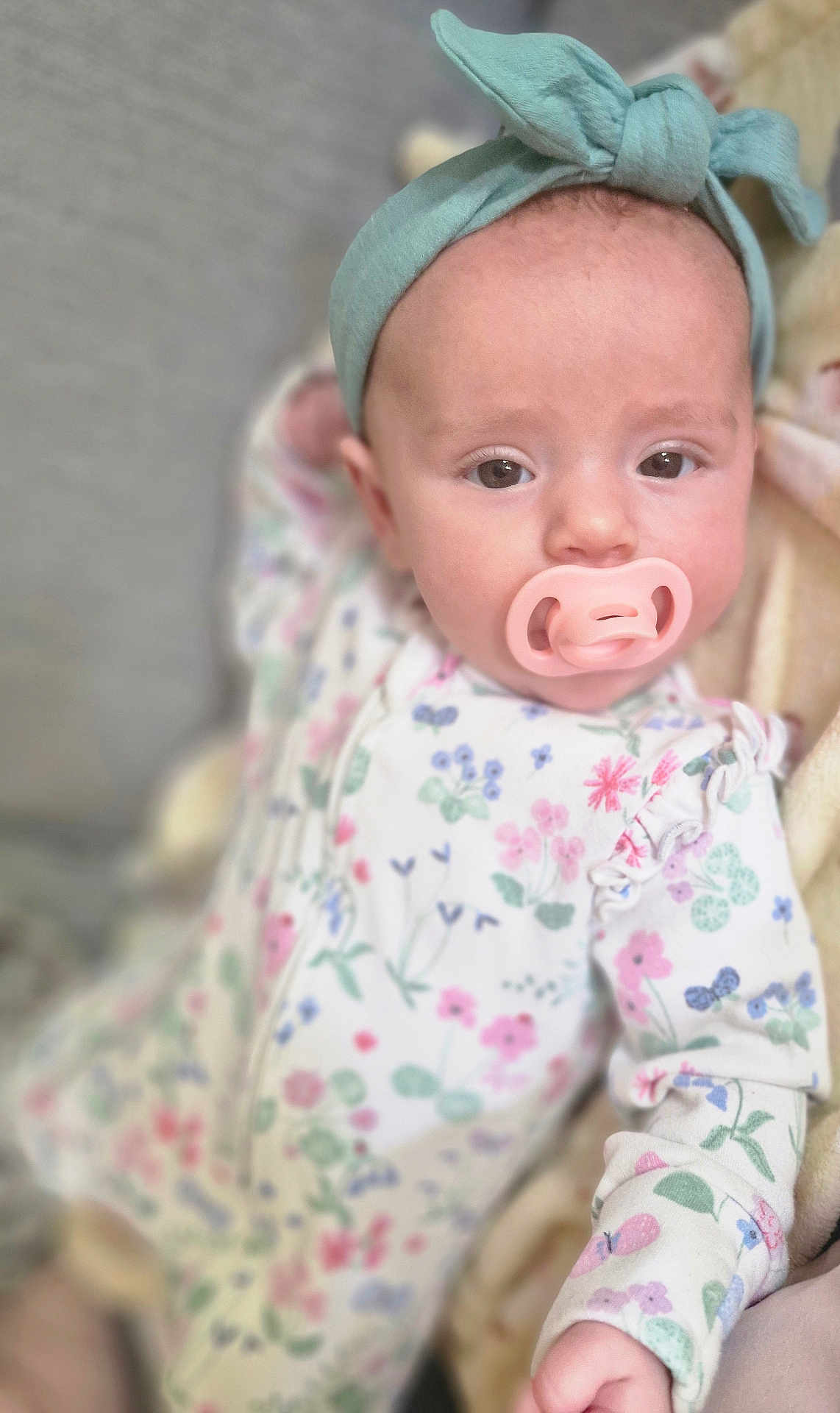 Seren-Journey joined the competition — help win amazing prizes! baby, infant, pacifier, headband, floral_onesie, blanket, closeup, cute, child, soft_focus, indoors, sleepwear, portrait, young_child, resting, comfort, skin, hand, expression, lying_down