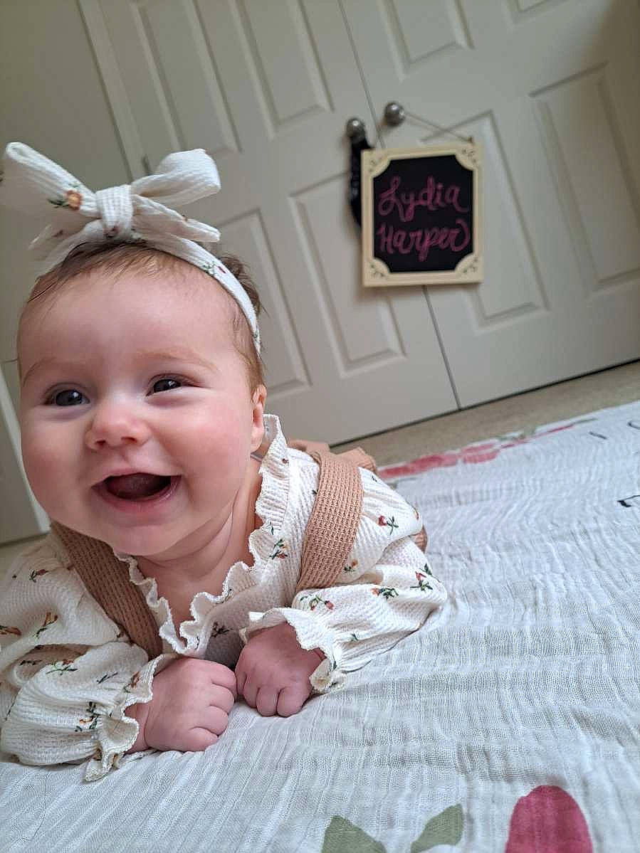 Lydia joined the competition — help win amazing prizes! baby, baby_toddler_clothing, cheek, embellishment, fashion_accessory, flooring, fun, happy, headband, headgear, headpiece, human_body, iris, jewellery, lip, pattern, person, room, smile, toddler