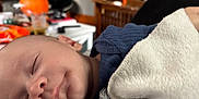 Levi is registered to the contest to win money with this photo: baby, sleeping, blanket, indoor, cozy, face, peaceful, child, human, portrait, soft, closeup, infant, rest, comfort, clothing, home, furniture, pumpkin, blurred_background