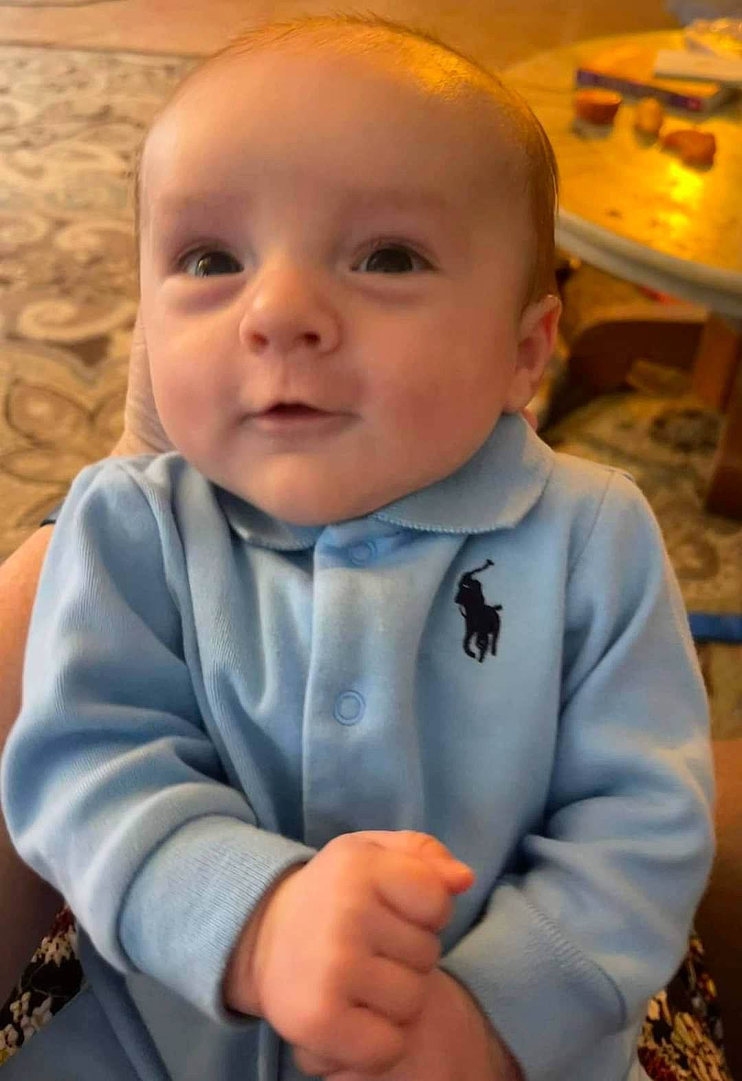 Carter is registered to the contest to win money with this photo: baby, baby_toddler_clothing, cheek, chin, collar, finger, fun, gesture, happy, head, iris, mouth, nose, person, skin, sleeve, smile, standing, thumb, toddler