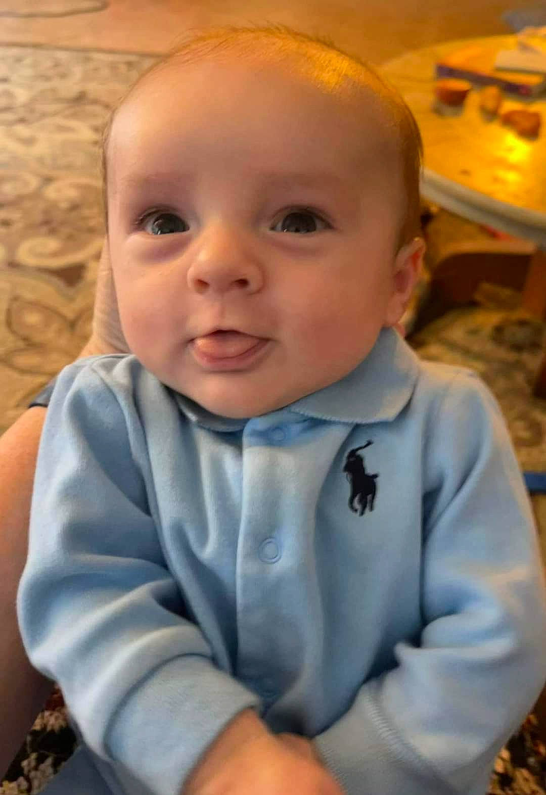 Carter is registered to the contest to win money with this photo: arm, baby, baby_toddler_clothing, cheek, child, chin, comfort, flooring, fun, gesture, grass, happy, iris, nose, person, sitting, skin, sleeve, smile, toddler