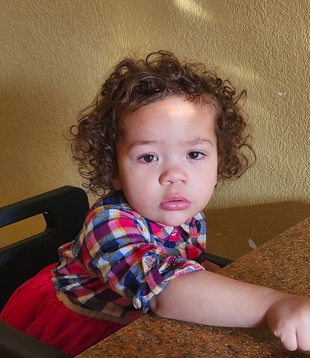 Ray Ray is registered to the contest to win money with this photo: baby_toddler_clothing, beauty, brown_hair, cheek, child, comfort, eye, flash_photography, flooring, fun, head, iris, pattern, person, plaid, room, sitting, skin, sleeve, toddler