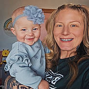 Ryder is registered to the contest to win money with this photo: baby, woman, mother, smile, portrait, indoor, headband, flower_headband, braces, tattoo, holding, nursery, crib, toy, hair, clothing, hand, face, happy, person