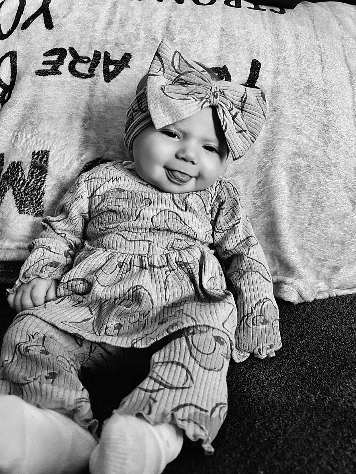 Tessa joined the competition — help win amazing prizes! baby, baby_toddler_clothing, black_and_white, child, font, gesture, happy, headwear, illustration, monochrome, monochrome_photography, pattern, person, photo_caption, photograph, sitting, sleeve, smile, stock_photography, style