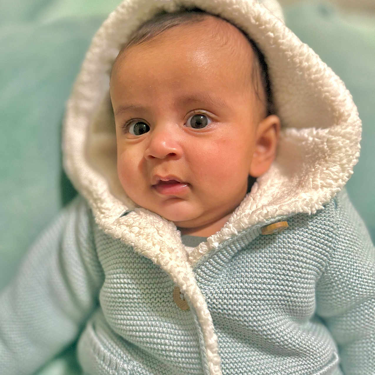 Zephyr is registered to the contest to win money with this photo: applique, baby, beanie, bonnet, cap, clothing, face, happy, hat, head, hood, hoodie, knitwear, newborn, person, photography, portrait, smile, sweater, sweatshirt