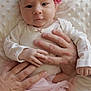 baby, infant, headband, pink_flower, hands, blanket, soft_texture, white_blanket, cute, clothing, pastel_colors, animal_prints, tulle_skirt, portrait, indoor, newborn, holding, skin, face, curious