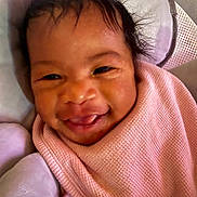 Divinity is registered to the contest to win money with this photo: baby, infant, smile, tongue, blanket, pink, pillow, face, closeup, cute, child, cozy, happy, skin, hair, indoors, soft, warm, wrapped, expression