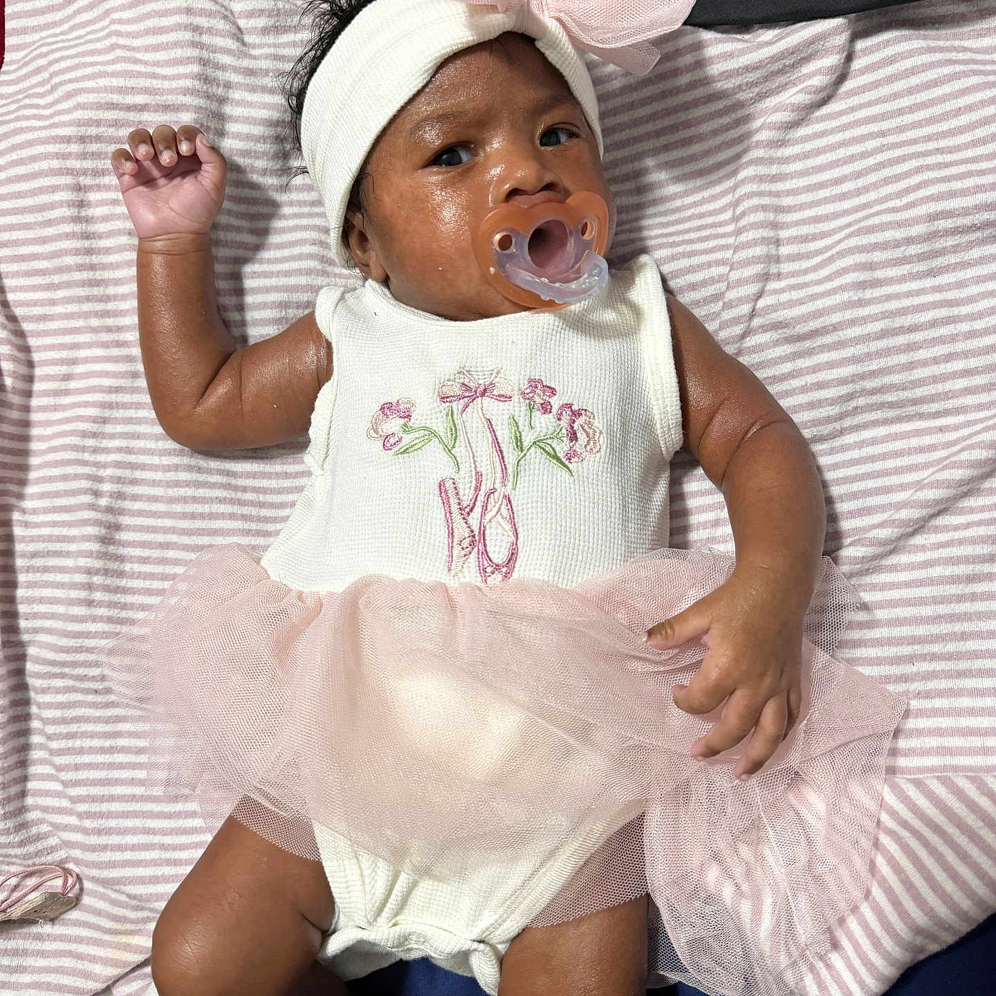 Divinity joined the competition — help win amazing prizes! baby, infant, pacifier, headband, bow, tutu, pink, white, striped_blanket, clothing, lying_down, cute, child, young, skin, hand, foot, indoors, fabric, portrait