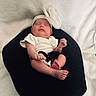 Amiracle joined the competition — help win amazing prizes! baby, black_cushion, bow, child, cozy, cute, headband, indoors, infant, newborn, peaceful, person, portrait, resting, sleep, sleeping, small_feet, small_hands, soft_background, white_clothing
