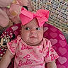 baby, barbie_outfit, child, childrens_room, closeup, crocheted_blanket, curious_expression, cute, headwear, heart_pattern, indoors, infant, mickey_mouse_cushion, patterned_clothing, pink, pink_bow, plush_toy, portrait, seated, soft_texture