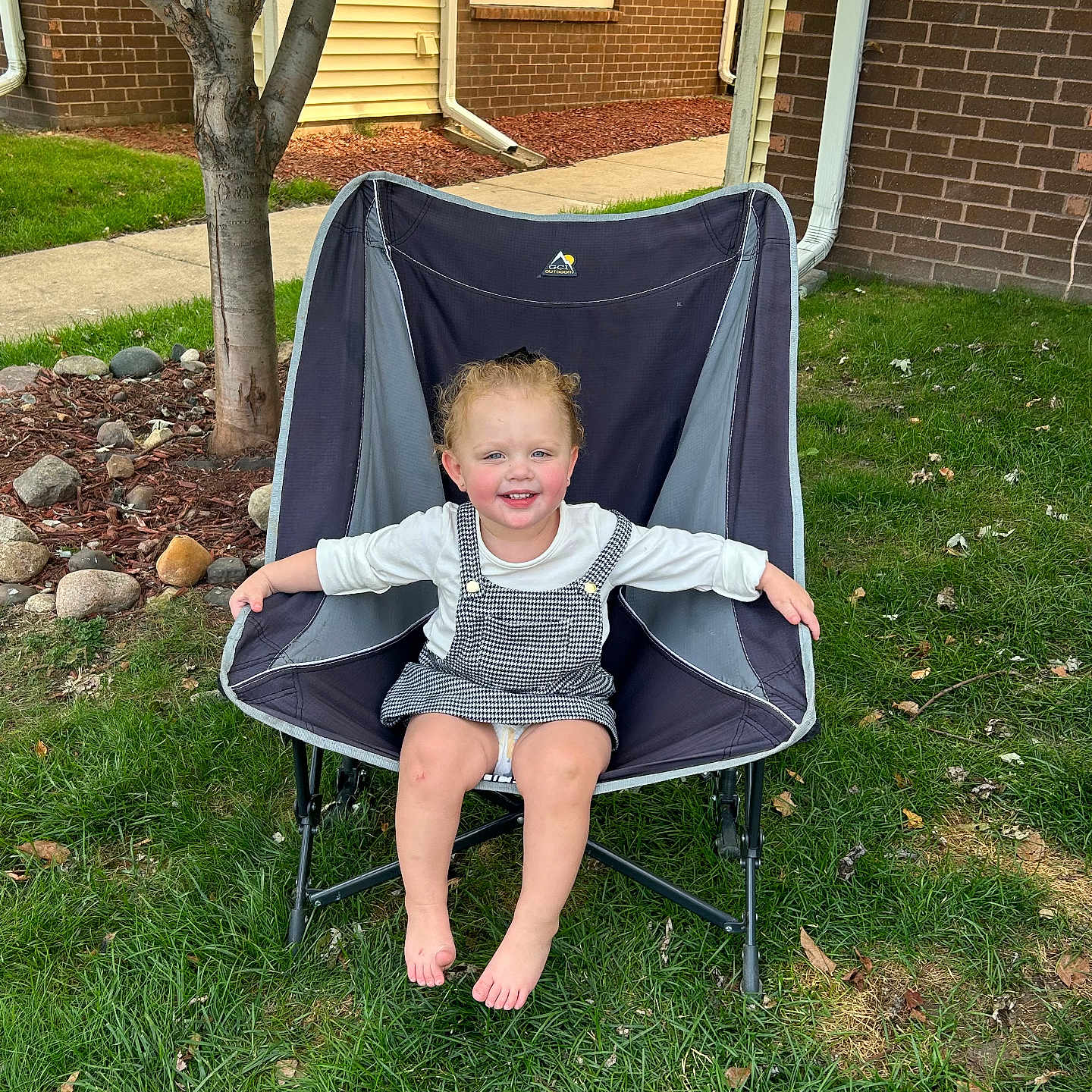 Evelyn is registered to the contest to win money with this photo: architecture, baby, backyard, building, chair, face, furniture, grass, head, nature, outdoors, person, photography, plant, portrait, shelter, sitting, summer, tree, yard