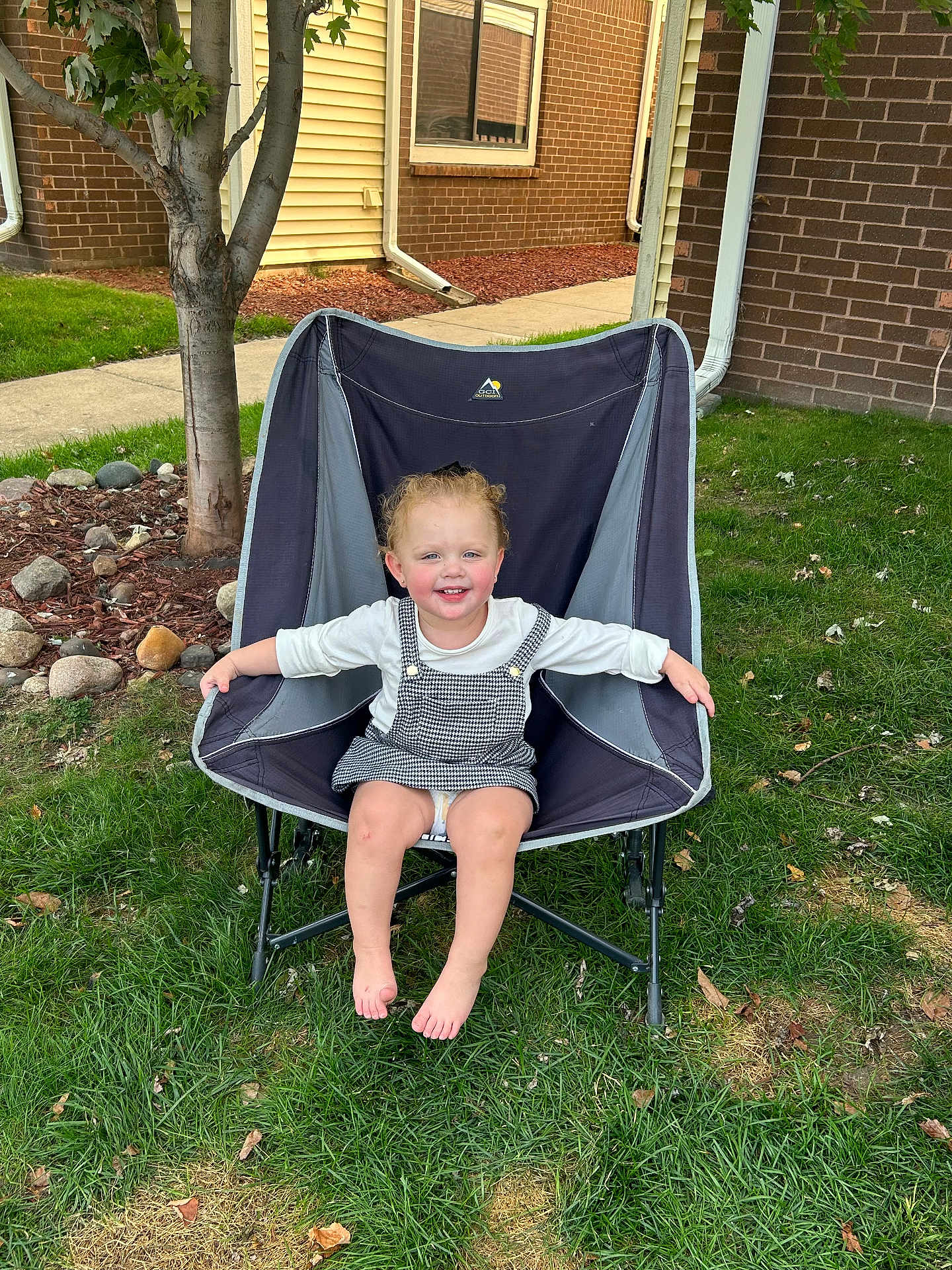 Evelyn is registered to the contest to win money with this photo: architecture, baby, backyard, building, chair, face, furniture, grass, head, nature, outdoors, person, photography, plant, portrait, shelter, sitting, summer, tree, yard