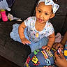 toddler, child, bow_headband, blue_dress, tutu, couch, marvel_comics, sippy_cup, indoor, person, happy, climbing, toy, necklace, hand, fabric, patterned_clothing, playful, cute, young_child