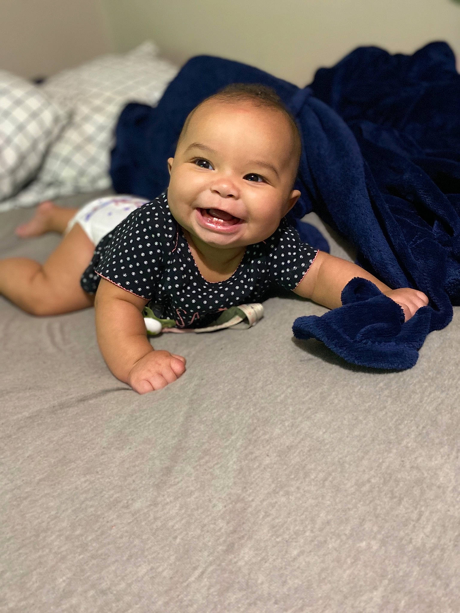 Ava Grace is registered to the contest to win money with this photo: baby, beauty, cheek, child, crawling, design, face, facial_expression, floor, flooring, head, joy, nose, pattern, person, photography, sitting, skin, smile, toddler