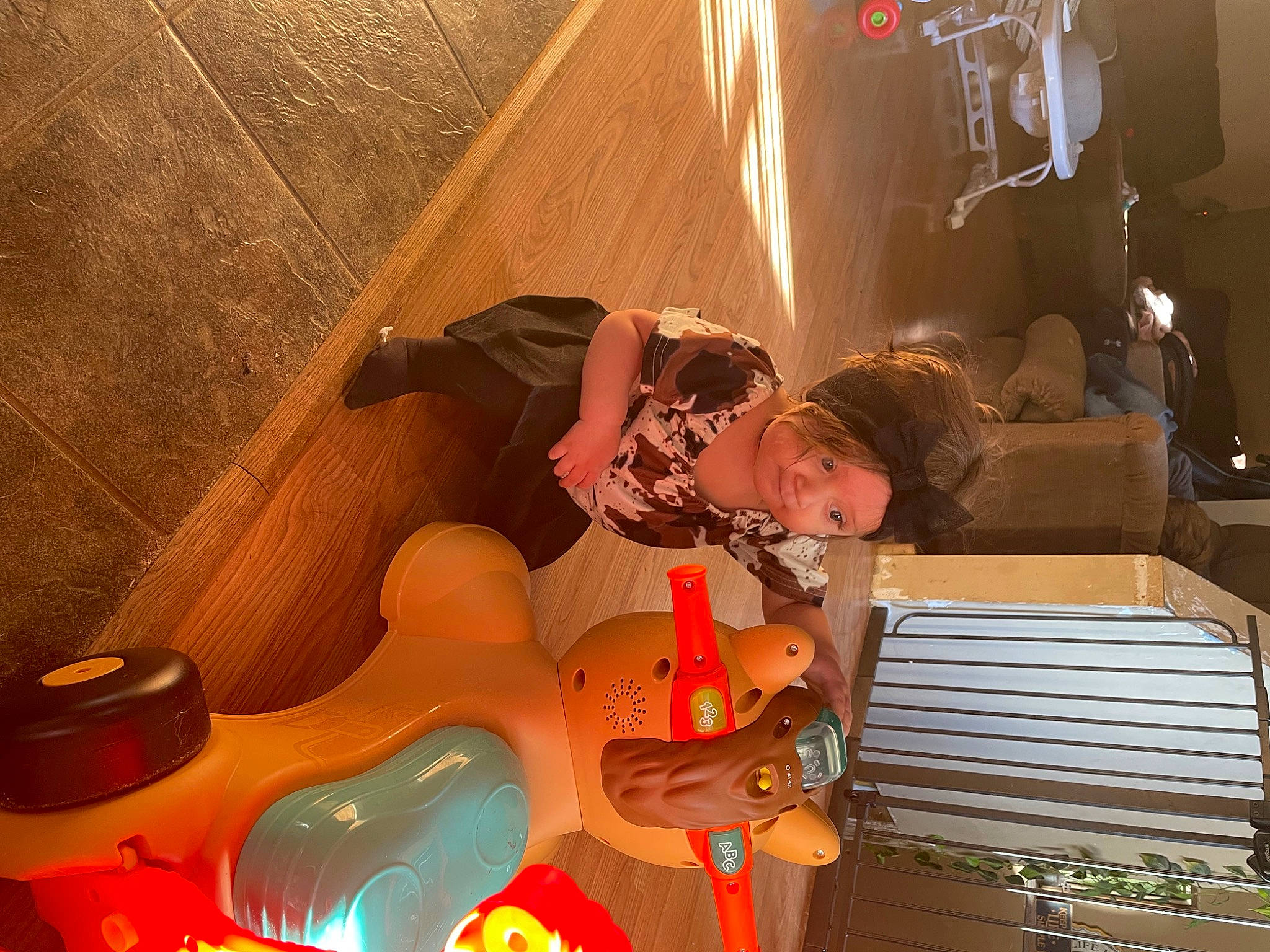 Peyton is registered to the contest to win money with this photo: animation, cg_artwork, child, entertainment, event, fictional_character, fun, games, happy, headwear, leisure, lighting, pc_game, person, play, recreation, room, sitting, space, toddler