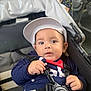 Nino a rejoint le concours — aidez-le/la à gagner de superbes lots ! baby, child, stroller, cap, hat, harness, blue_clothing, face, hand, infant, sitting, straps, cute, portrait, young_child, looking, indoors, closeup, person, seat