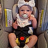 adorable, baby, car_safety, car_seat, child, clothing, cute, expression, headwear, indoor, infant, pacifier, person, safety, seatbelt, sitting, socks, warning_label, white_bow, young_child