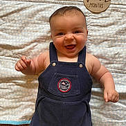 Oliver is registered to the contest to win money with this photo: accessories, baby, babylaughing, clothing, dress, face, happy, head, jeans, jewelry, laughing, necklace, pants, person, photography, portrait, quilt, smile, strap, vest