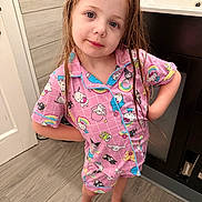Julianna is registered to the contest to win money with this photo: child, pajamas, wet_hair, standing, bathroom, floor, sink, wooden_floor, pink_clothing, cartoon_characters, confident_pose, barefoot, young_child, cute, indoor, smiling, person, home, toddler, casual