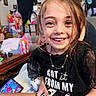 Alyssa is registered to the contest to win money with this photo: child, girl, smile, happy, controller, gaming, indoor, toy, colorful, room, casual, portrait, joy, playful, young, person, clothing, necklace, hair, furniture