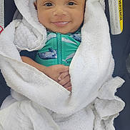 Luciano joined the competition — help win amazing prizes! baby, smiling, towel, white, car_seat, green_outfit, whale_print, infant, wrapped, cozy, cute, child, portrait, face, hands, happy, indoors, seat, warning_label, closeup