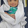baby, smiling, towel, white, car_seat, green_outfit, whale_print, infant, wrapped, cozy, cute, child, portrait, face, hands, happy, indoors, seat, warning_label, closeup